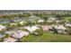 An aerial view of a neighborhood showcasing lush landscaping, serene water features, and tile roof homes at 3010 Winding Trl, Kissimmee, FL 34746