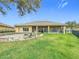 Backyard featuring circular brick paver patio, lush lawn, landscaping and patio at 3010 Winding Trl, Kissimmee, FL 34746