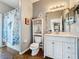 Bathroom featuring vanity with sink, seashell decor, mirror, and tiled floors at 3010 Winding Trl, Kissimmee, FL 34746
