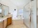 Bright bathroom features a shower and jacuzzi at 3010 Winding Trl, Kissimmee, FL 34746