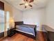 Cozy bedroom features wood floors, ceiling fan and dresser at 3010 Winding Trl, Kissimmee, FL 34746