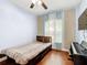 Cozy bedroom features wood floors, ceiling fan and large window at 3010 Winding Trl, Kissimmee, FL 34746