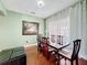 Elegant dining room features a wooden table, six chairs, and decorative curtains, creating a warm atmosphere at 3010 Winding Trl, Kissimmee, FL 34746