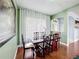 Elegant dining room features a wooden table, six chairs, and decorative curtains, creating a warm atmosphere at 3010 Winding Trl, Kissimmee, FL 34746