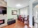 Bright dining room featuring wood floors, light green walls, and large window with elegant curtains at 3010 Winding Trl, Kissimmee, FL 34746