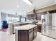Modern kitchen boasts stainless steel appliances, a center island, and seamless flow to the breakfast area at 3010 Winding Trl, Kissimmee, FL 34746