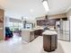 Modern kitchen boasts stainless steel appliances, a center island, and seamless flow to the breakfast area at 3010 Winding Trl, Kissimmee, FL 34746