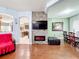 Spacious living room featuring a stone accent wall with fireplace and wood floors at 3010 Winding Trl, Kissimmee, FL 34746