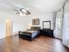 Spacious bedroom with wood floors, large windows, and decorative curtains, creating an inviting retreat at 3010 Winding Trl, Kissimmee, FL 34746