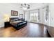 Spacious bedroom with wood floors, large windows, and decorative curtains, creating an inviting retreat at 3010 Winding Trl, Kissimmee, FL 34746