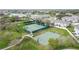 Community tennis courts with green fencing, adjacent to a basketball court and winding path at 3010 Winding Trl, Kissimmee, FL 34746