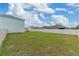 Large, grassy backyard featuring a privacy fence at 3188 Serendipity Way, Davenport, FL 33896