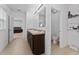 Bathroom featuring double sinks, tan tile flooring, and a mirror with overhead lights at 3188 Serendipity Way, Davenport, FL 33896