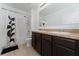 Well-lit bathroom featuring a double vanity with dark cabinets and a shower-tub combination at 3188 Serendipity Way, Davenport, FL 33896