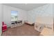 Charming bedroom with a play tent, colorful wall art, and natural light from a window at 3188 Serendipity Way, Davenport, FL 33896