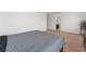 Carpeted bedroom features a queen-sized bed with gray bedding, with an adjoining bathroom and views to the hallway at 3188 Serendipity Way, Davenport, FL 33896