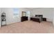 Spacious carpeted bedroom featuring large windows, a dresser, and a queen-sized bed with matching nightstands at 3188 Serendipity Way, Davenport, FL 33896