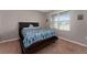 Comfortable bedroom featuring a full-sized bed, soft carpet, and a bright window at 3188 Serendipity Way, Davenport, FL 33896