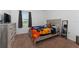 Cozy bedroom with a queen bed, dresser, mirror, and a large window at 3188 Serendipity Way, Davenport, FL 33896