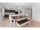 Bright dining area featuring a large wooden table with chairs and bench seating at 3188 Serendipity Way, Davenport, FL 33896