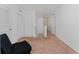 Spacious hallway with carpet flooring, multiple doors, and a comfortable chair at 3188 Serendipity Way, Davenport, FL 33896