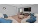 Bright living room featuring comfortable seating, a large television, and neutral décor at 3188 Serendipity Way, Davenport, FL 33896