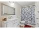 Bright bathroom featuring a sink, mirror, modern vanity, toilet, and shower with tub at 3203 Rio Grande Trl, Kissimmee, FL 34741