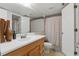 Well-lit bathroom with a spacious mirror, sink, wood cabinets, and a shower with tub at 3203 Rio Grande Trl, Kissimmee, FL 34741