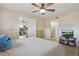Bright bedroom with ceiling fan and TV, plus entry to stairway and the Primary bath at 3203 Rio Grande Trl, Kissimmee, FL 34741