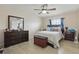 Cozy bedroom featuring a ceiling fan, dresser with mirror, and a comfortable bed at 3203 Rio Grande Trl, Kissimmee, FL 34741