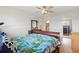 Large bedroom with ceiling fan, dresser with mirror, and comfy bed, plus view to bath at 3203 Rio Grande Trl, Kissimmee, FL 34741