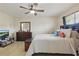 Spacious bedroom with a fan, large dresser, comfortable bed, and a TV on display at 3203 Rio Grande Trl, Kissimmee, FL 34741