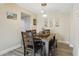 Cozy dining area featuring pendant lighting, wood-look flooring, and access to the kitchen, perfect for Gathering meals at 3203 Rio Grande Trl, Kissimmee, FL 34741