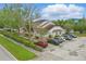 Exterior of multi-unit dwelling with ample parking spaces, and maintained landscaping at 3203 Rio Grande Trl, Kissimmee, FL 34741