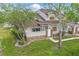 Inviting townhouse with well-maintained lawn and mature trees, showcasing the exterior's tidy landscaping and appealing design at 3203 Rio Grande Trl, Kissimmee, FL 34741