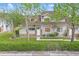 Charming townhouse featuring neutral siding, brick accents, lush landscaping, and a welcoming walkway to the entrance at 3203 Rio Grande Trl, Kissimmee, FL 34741