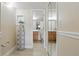 Hallway leads to the bathroom with vanity and toilet, plus ironing board and shelf at 3203 Rio Grande Trl, Kissimmee, FL 34741