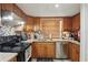 Traditional kitchen with stainless steel appliances, granite countertops, and wood cabinetry at 3203 Rio Grande Trl, Kissimmee, FL 34741