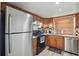 Functional kitchen with stainless steel appliances, wood cabinetry, and a tile backsplash, ready for culinary adventures at 3203 Rio Grande Trl, Kissimmee, FL 34741