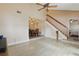Open-concept living space featuring wood-look flooring, a staircase, and a dining area, creating a seamless flow at 3203 Rio Grande Trl, Kissimmee, FL 34741