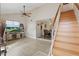 Bright living room featuring vaulted ceilings, wood-look floors, and a staircase leading to the upper level at 3203 Rio Grande Trl, Kissimmee, FL 34741