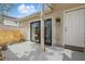 Exterior patio featuring sliding glass doors, white siding, and a small garden adding natural charm at 3203 Rio Grande Trl, Kissimmee, FL 34741