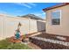 Beautifully landscaped backyard with mulch, stone pathway, and privacy fence at 3471 Julius Estates Blvd, Winter Haven, FL 33881