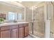 Bathroom featuring double sinks and a glass enclosed walk-in shower with tile surround at 3471 Julius Estates Blvd, Winter Haven, FL 33881