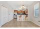 Open-concept dining area next to kitchen, featuring modern chandelier and lots of natural light at 3471 Julius Estates Blvd, Winter Haven, FL 33881