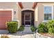 Inviting front entrance featuring well-maintained landscaping, stone accents, and a screened door at 3471 Julius Estates Blvd, Winter Haven, FL 33881