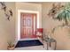 Inviting front entryway with a charming red door and decorative accents for a warm welcome at 3471 Julius Estates Blvd, Winter Haven, FL 33881