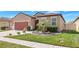Charming home with meticulously landscaped front yard, lush lawn, and decorative features at 3471 Julius Estates Blvd, Winter Haven, FL 33881