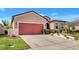 Beautiful single-Gathering home featuring a well-manicured lawn, and red garage door at 3471 Julius Estates Blvd, Winter Haven, FL 33881