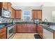 Beautiful kitchen featuring stainless steel appliances, granite countertops, and warm wooden cabinetry at 3471 Julius Estates Blvd, Winter Haven, FL 33881